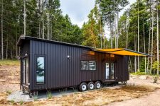 01 This tiny house on wheels is a stylish home with a black exterior and a spacious interior