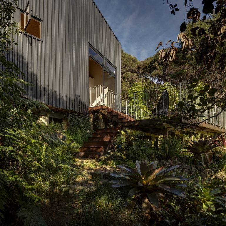 The house has two outdoor decks surrounded by dense vegetation and with access to the immediate surroundings