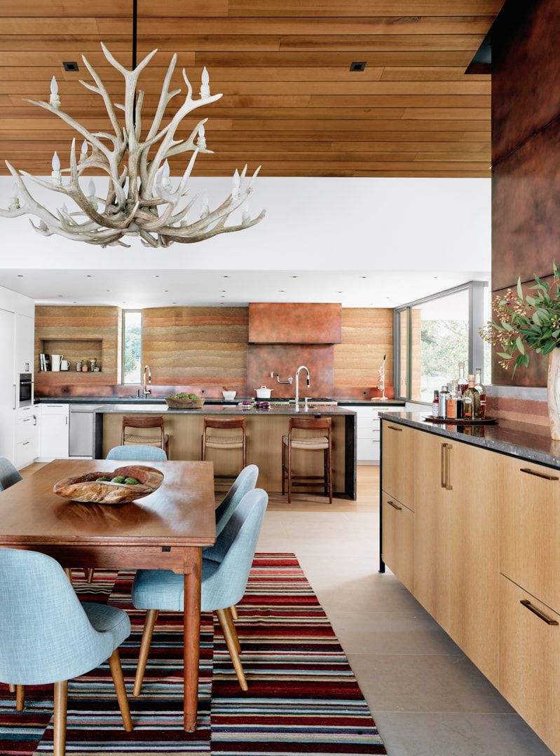 The kitchen and dining space are done in warm sandy shades and the design reminds of canyons