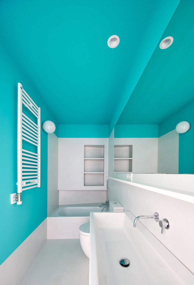 The bathroom is done with color blocking, and bright blue raises the mood at once