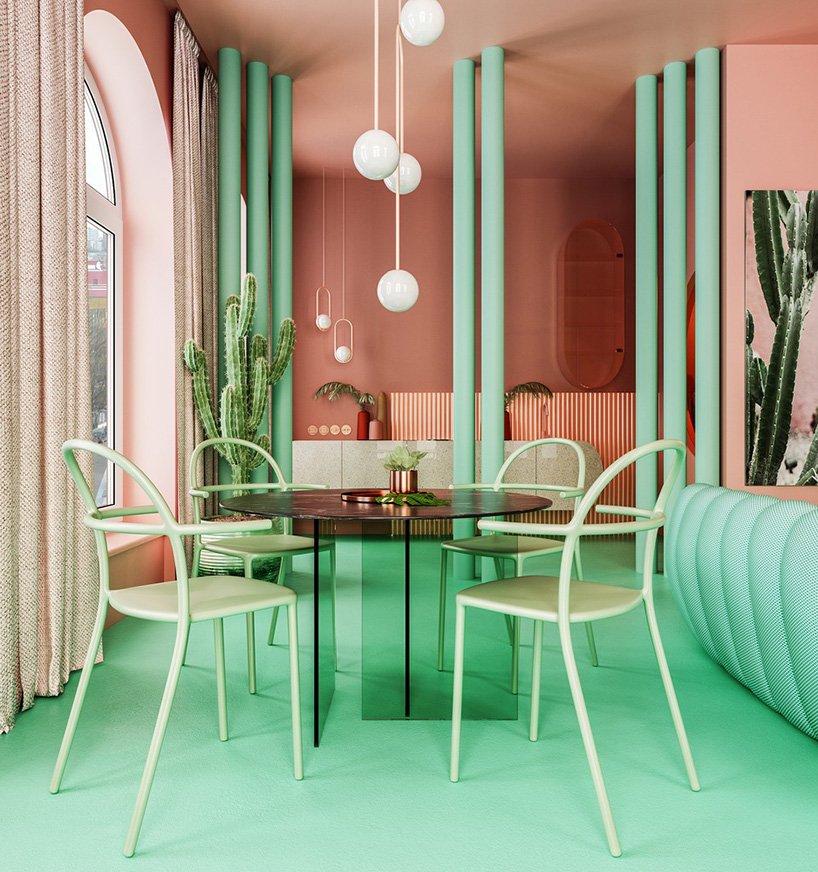 The dining space shows off a green glass table and green chairs plus pendant lamps