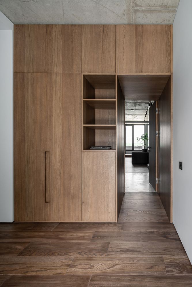 The bedroom is accessed through a small corridor lined with wood