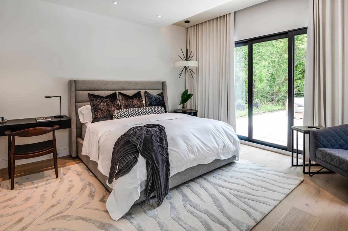 The master bedroom is neutral, with chic furniture, built-in lights and much natural light, too