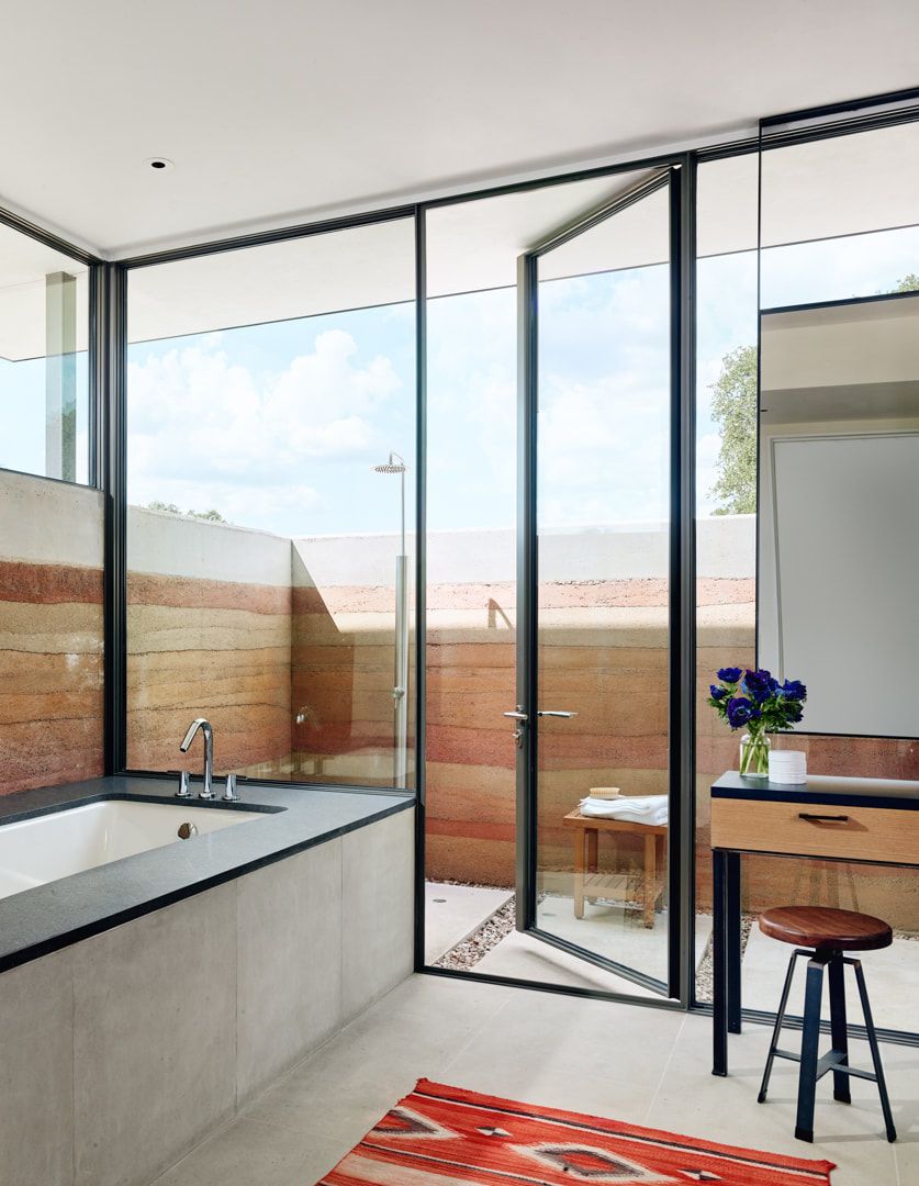 The bathroom is partly indoor and partly outdoor to enjoy showers when the weather is warm