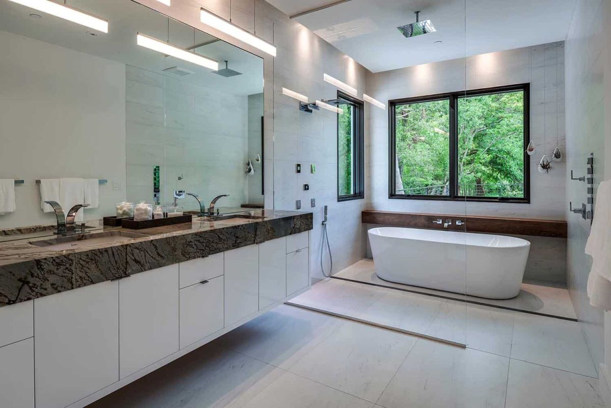 The master bathroom is also neutral, with a stone countertop that contrasts and lots of light