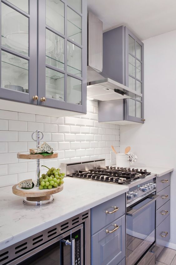 a chic lilac kitchen with a white subway tile backsplash and white stone countertops looks very romantic
