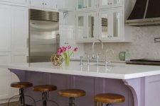 a neutral vintage kitchen with a lilac kitchen island, white countertops, a whte tile backsplash and wooden stools