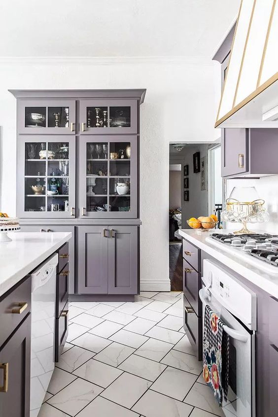 a purple kitchen with white touches to refresh it and some gold touches to make it super cool and chic