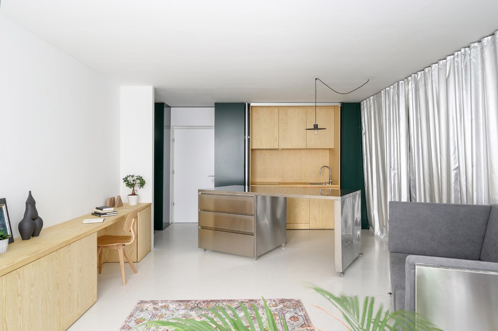 This modern apartment is created for the owners with a dynamic lifestyle and features mobile stainless steel furniture