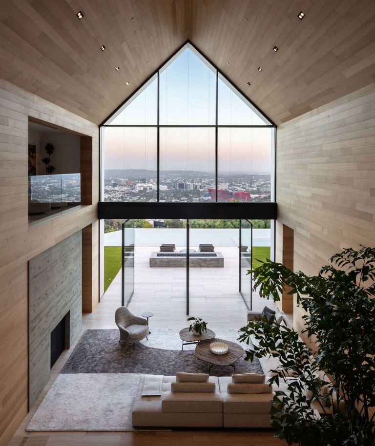 The space is clad with sleek and plain wood, there's little furniture to emphasize the views