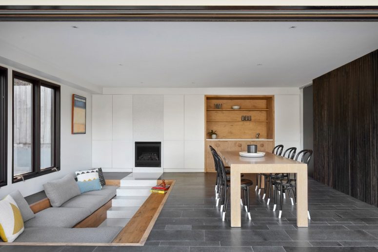 This space is done for having guests - a conversation pit and a dining space enclosed