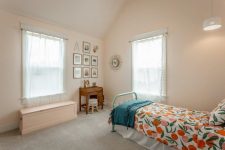 08 This bedroom done in blush shows off vintage furniture, a gallery wall and bright bedding