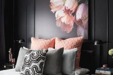 a refined moody bedroom with black walls, black furniture, pink and grey bedding and a pink floral artwork