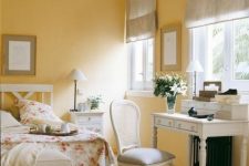 a romantic sunny yellow bedroom with refined vintage white furniture, dove grey textiles and floral bedding