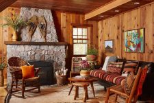 03 The living room is done with stained wood, vintage rustic furniture and a large stone hearth