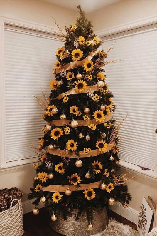 a stylish Thanksgiving tree with faux sunflowers, gold ornaments and branches plus burlap ribbons