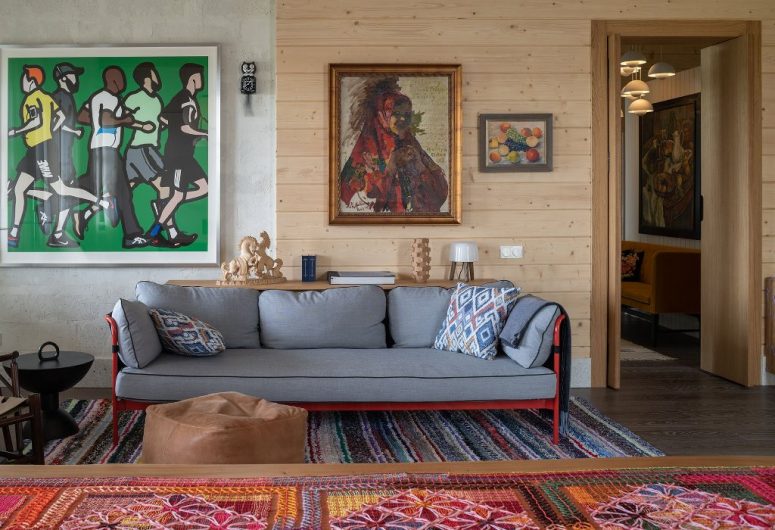 The living room shows off bright traditional textiles and neutral furniture plus bold artworks