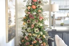 05 a bright and natural-looking Thanksgiving tree with various pumpkins, pinecones, faux flowers and branches