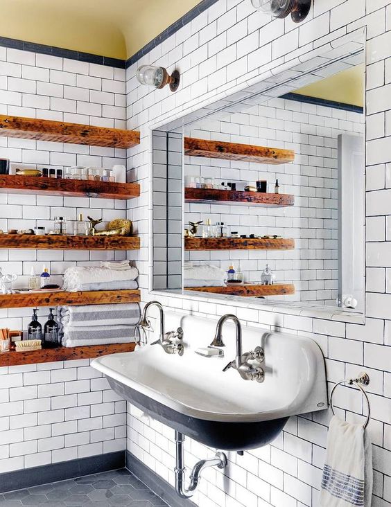 staiend wooden slab open shelves soften the vintage industrial bathroom making it look warmer