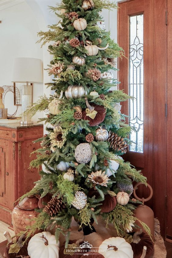 a chic Thanksgiving tree with oversized pinecones and white and metallic pumpkins, antlers, greenery and cotton balls