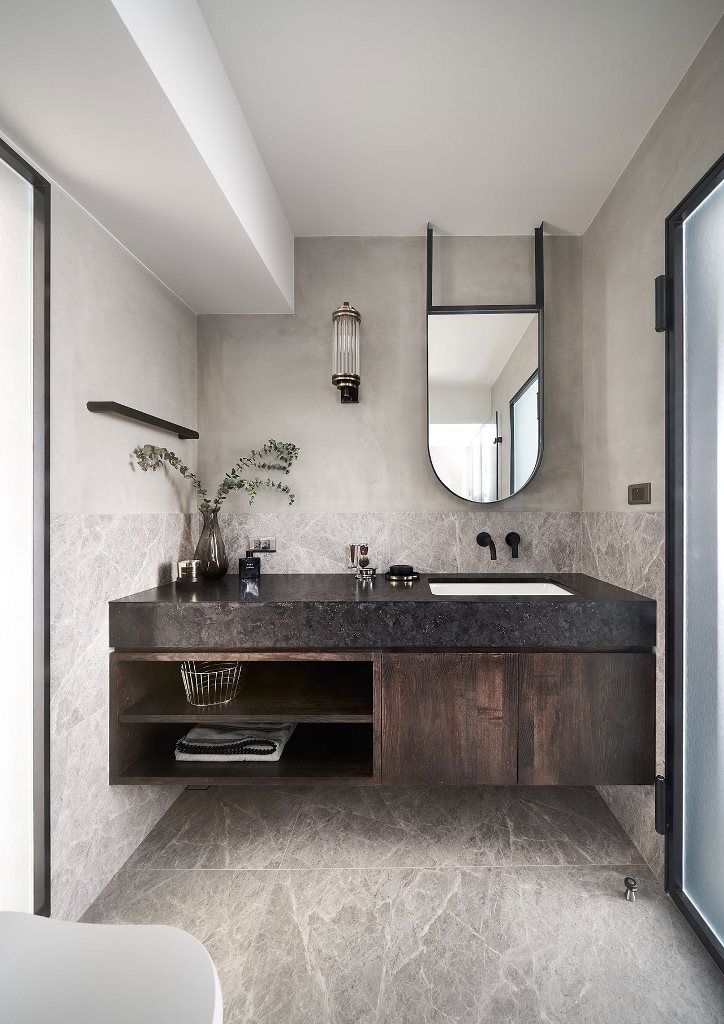 There's a floating vanity with a black countertop and some greenery