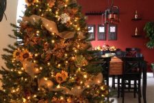 10 a cozy Thanksgiving tree decorated with lights, pinecones, faux sunflowers and faux white blooms plus burlap ribbons
