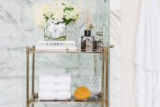 14 a refined gold and glass rolling cart is a gorgeous option for a sophisticated and chic bathroom