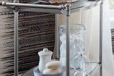 16 a refined stainless steel and glass rolling cart is a stylish storage piece with many items and some decor