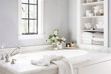 18 built-in shelves over the bathtub are a nice solution for storing a lot of things without wasting floor space