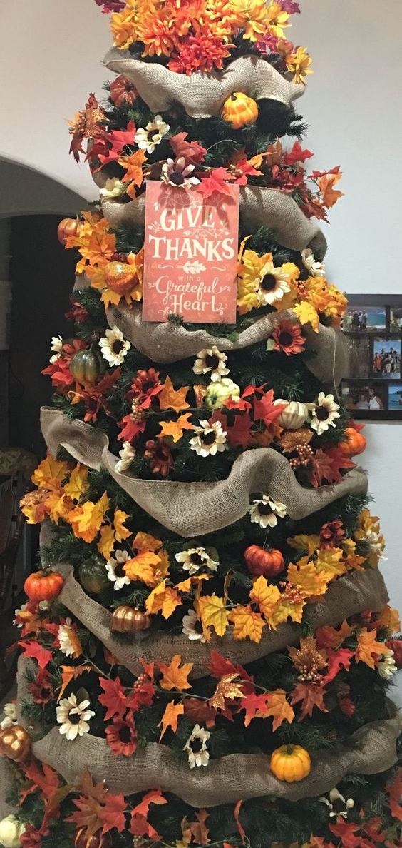 a stylish Thanksgiving tree with burlap ribbons, bright faux blooms and leaves and a chic sign