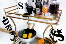 a halloween drink station with a letter garland