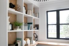 a farmhouse home office with open storage units and drawers, a corner desk, a white chair and a creative pendant lamp