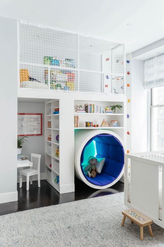 a unique kids' room with a study space, a reading sphere, an upper sleeping space and a climbing wall
