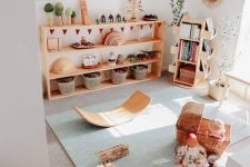 06 a cute and welcoming kids’ play space with natural wooden furniture, pretty toys and potted plants and botanical posters