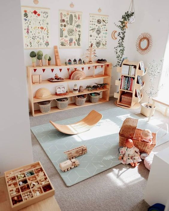 a cute and welcoming kids' play space with natural wooden furniture, pretty toys and potted plants and botanical posters