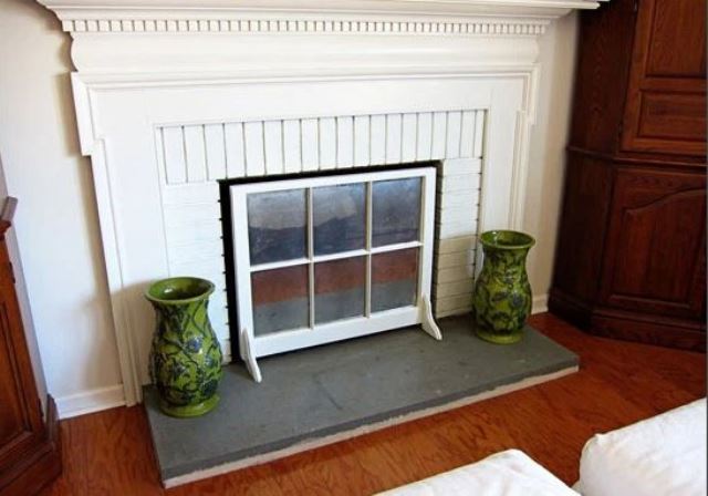 a non-working fireplace cover made of an old window frame is a stylish and very easy idea to go for