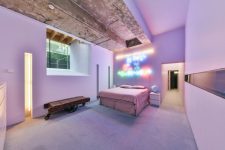 07 The aster bedroom is pink and lavender, with a neon sign and a rough concrete ceiling