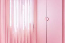 07 The storage is delicately hidden in the walls and the wardrobe features sleek and simple pink doors