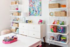 07 a colorful and bold playroom with open storage units, a bold artwork and bright rug, furniture and accessories