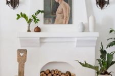 07 a stylish white non-working fireplace with very natural firewood inside is a chic idea with a rustic feel