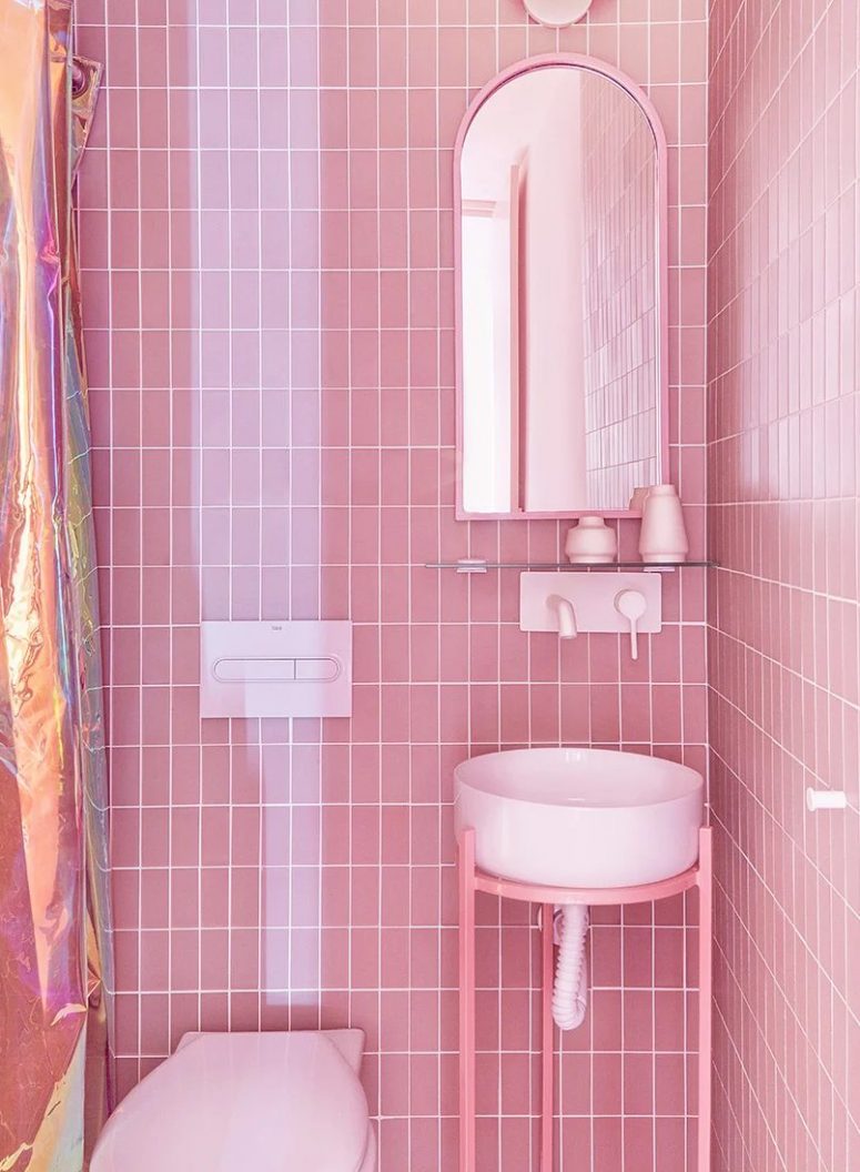 There's also another bathroom clad with pink tiles, a round sink and an arched mirror plus a shower space