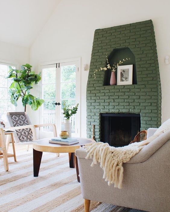a fireplace with a green brick surround brings color to this neutral space and makes it catchier and more interesting