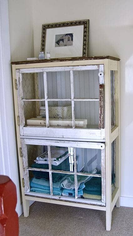 a shabby chic glass cabinet with old window frames instead of doors is a cool idea for a vintage bathroom