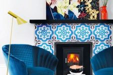 13 electric blue chairs, a bright blue printed rug, a bold blue tile fireplace and a colorful artwork create color galore that will raise your mood