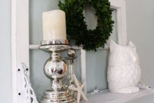 14 a small shelf with an old window frame as a base, mercury glass candleholders, a greenery wreath, an old is a stylish decoration for a vintage space