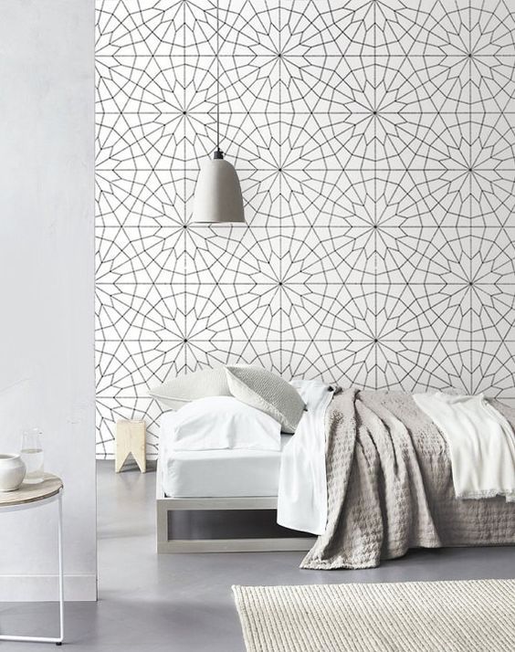 geometric flower wallpaper adds dimension to this bedroom and makes the neutral space look bold and very cool