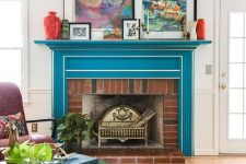 18 a bright mid-century modern living room with a bold blue mantel with white framing over a brick fireplace for ultimate elegance