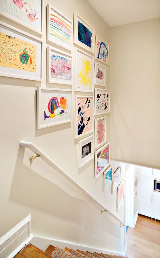 a stylish gallery wall over the staircase will display your kids' works at their best and they will be seen any time