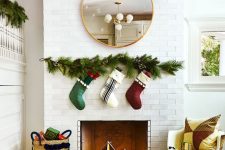 21 a non-working fireplace styled for Christmas with some stockings hanging over it and with lights lanterns inside it