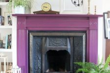 23 a vintage fireplace with a purple mantel around, some potted plants, candle lanterns and mirrors